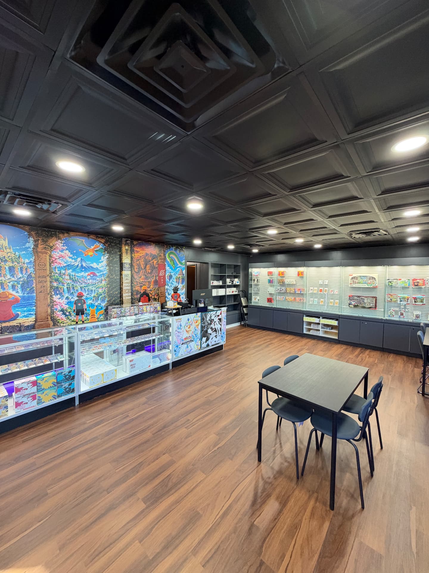 The Trading Vaults sales floor with counters, display cases and a table for collectors